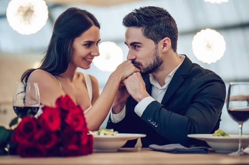 a man and woman having a romantic dinner