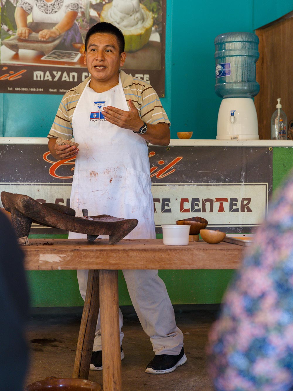 A guide demonstrating chocolate making during an Eco-Explorer outing