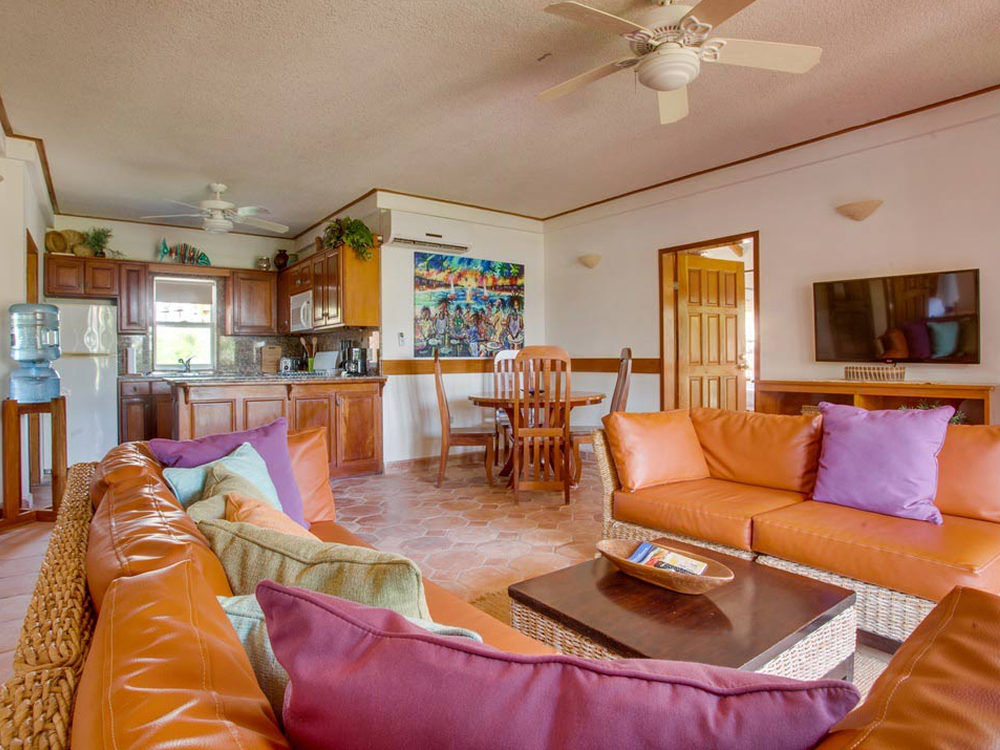 Living room, kitchen and dining area in a Belizean Dreams villa