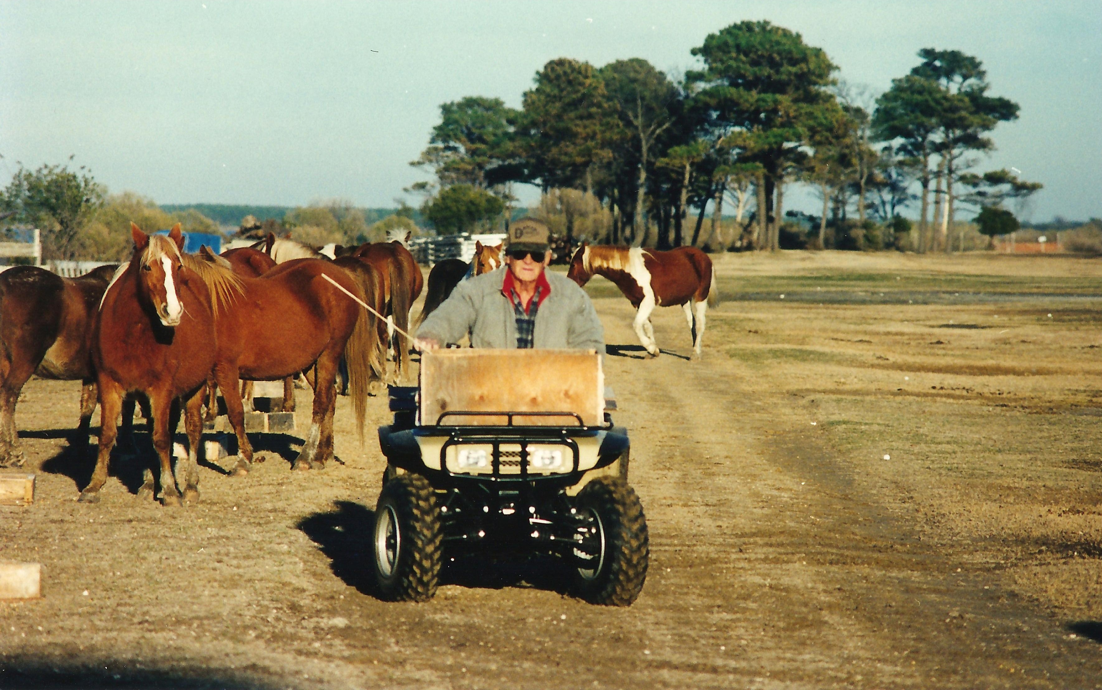 Donald Leonard drives his four-wheeler down Leonard Lane to feed his herd of ponies.