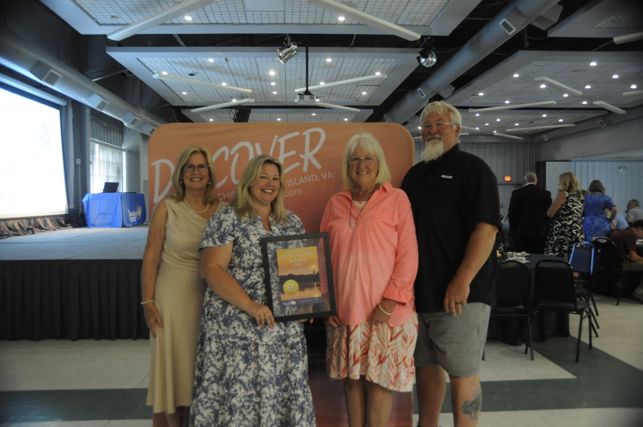 Jane, Cynthia, Donna and Arthur Leonard holding the Chincoteague Chamber of Commerce Beacon Award.