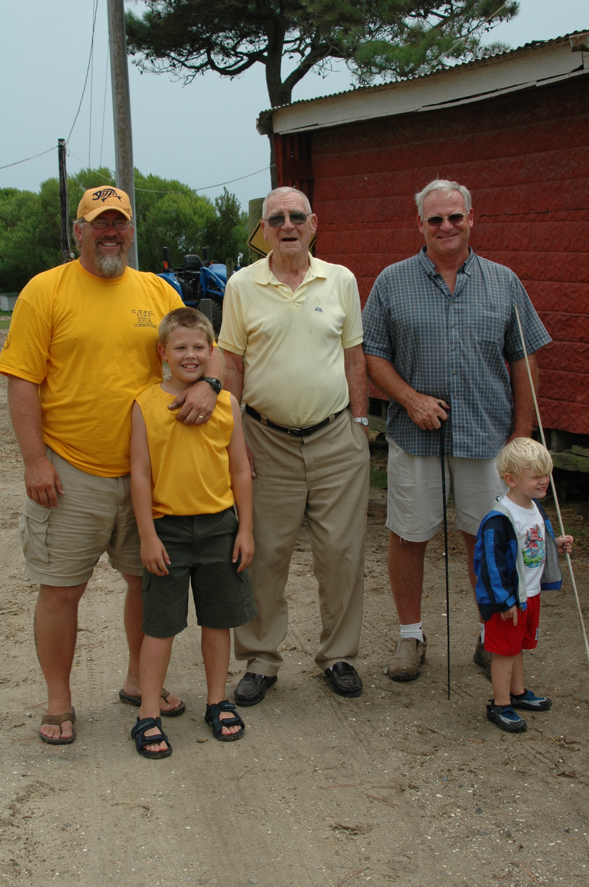 Five men of the Leonard family pose outside their barn on the Chincoteague Pony Farm.