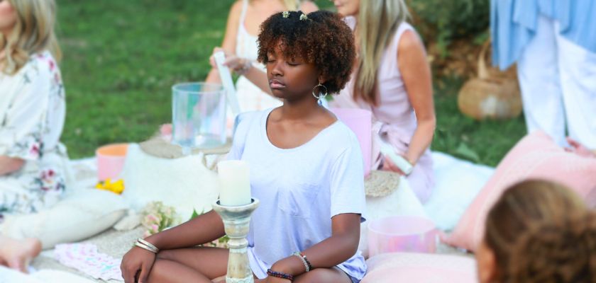 Guest meditating outdoors during a sound healing session at Honeys Farmhouse in Lothian, Maryland.