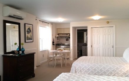 Bed and kitchenette view of Room 413 at Wades Point Inn on the Bay.