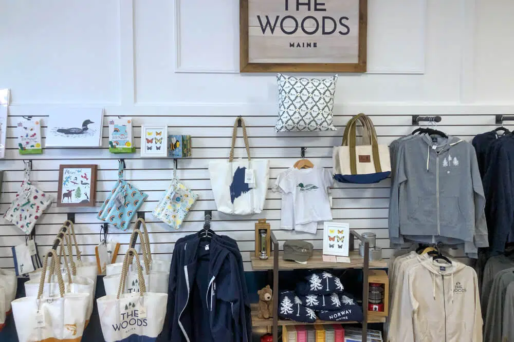 Sea bags and sweatshirts hanging on a shop wall
