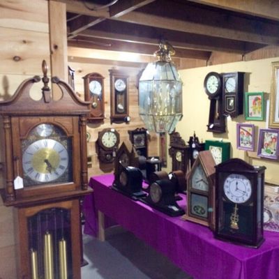 antique clock display at the willow flea market in maine