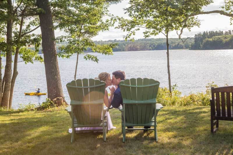 Couple Kissing Lakeside After Intimate Maine Wedding Reception