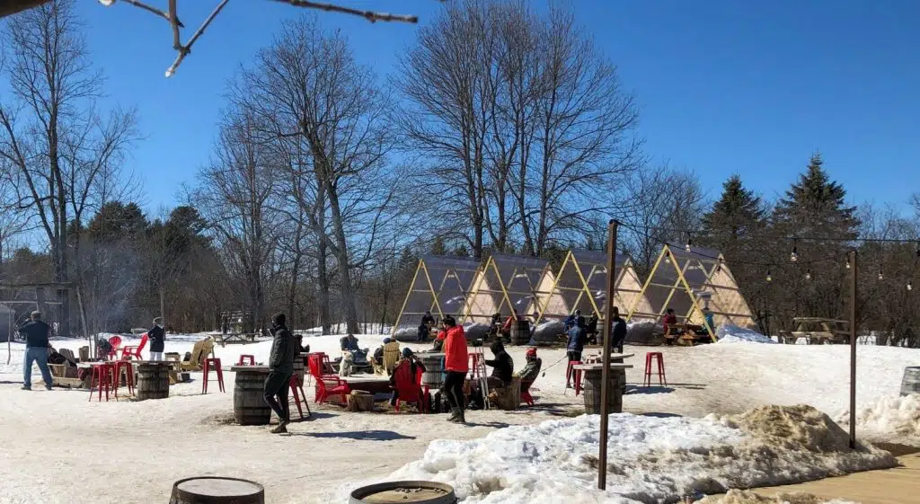 Outdoor beer garden with heated tents, fire pit tables