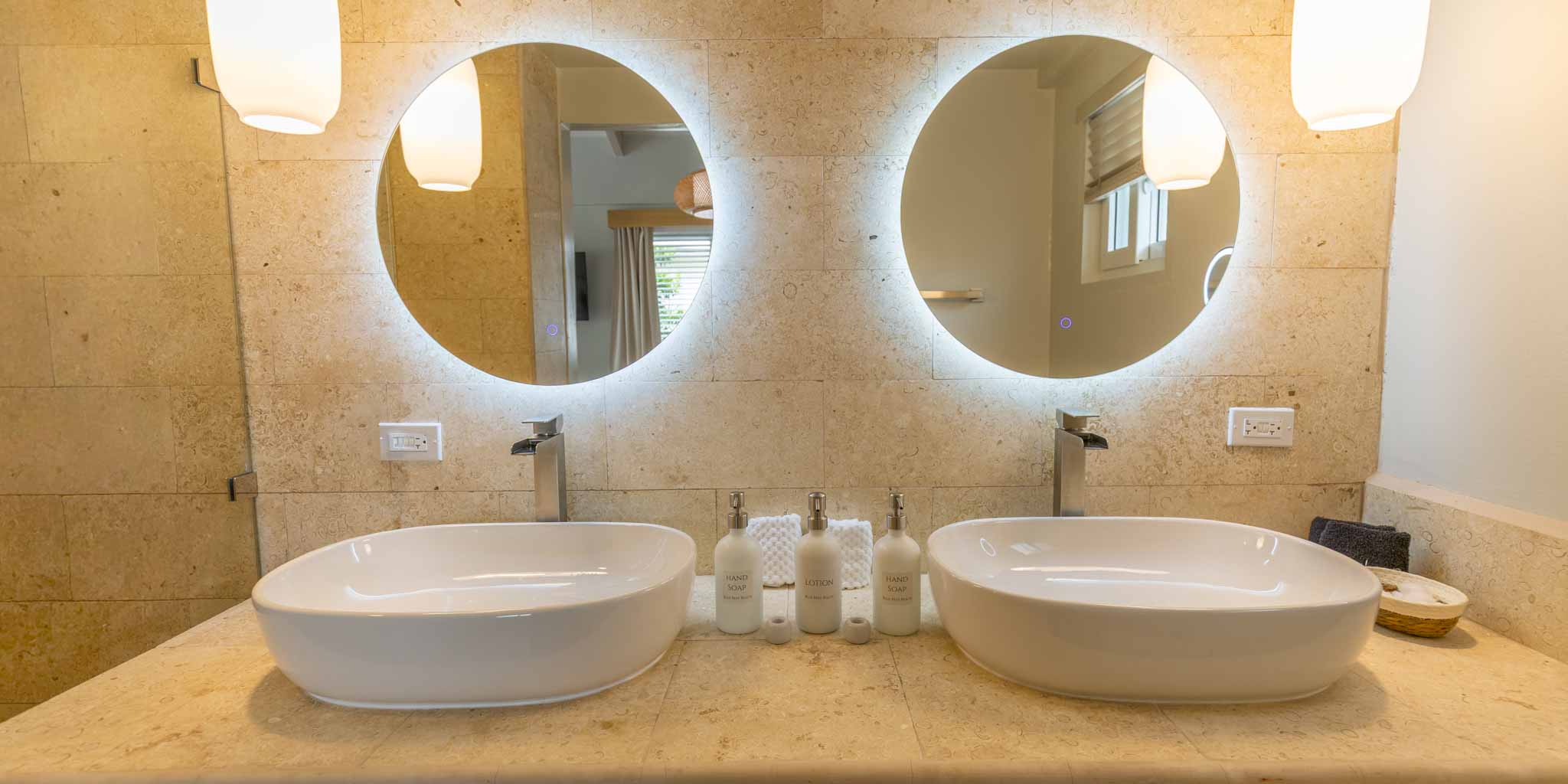 The double vanity mirrors and sink inside the poolview suites at Blue Reef Beach Resort in Placencia, Belize