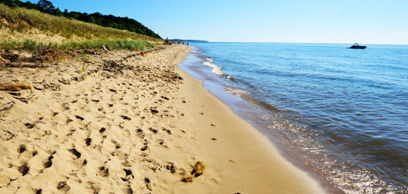 Water laps at the shore at Saugatuck Dunes State Park.