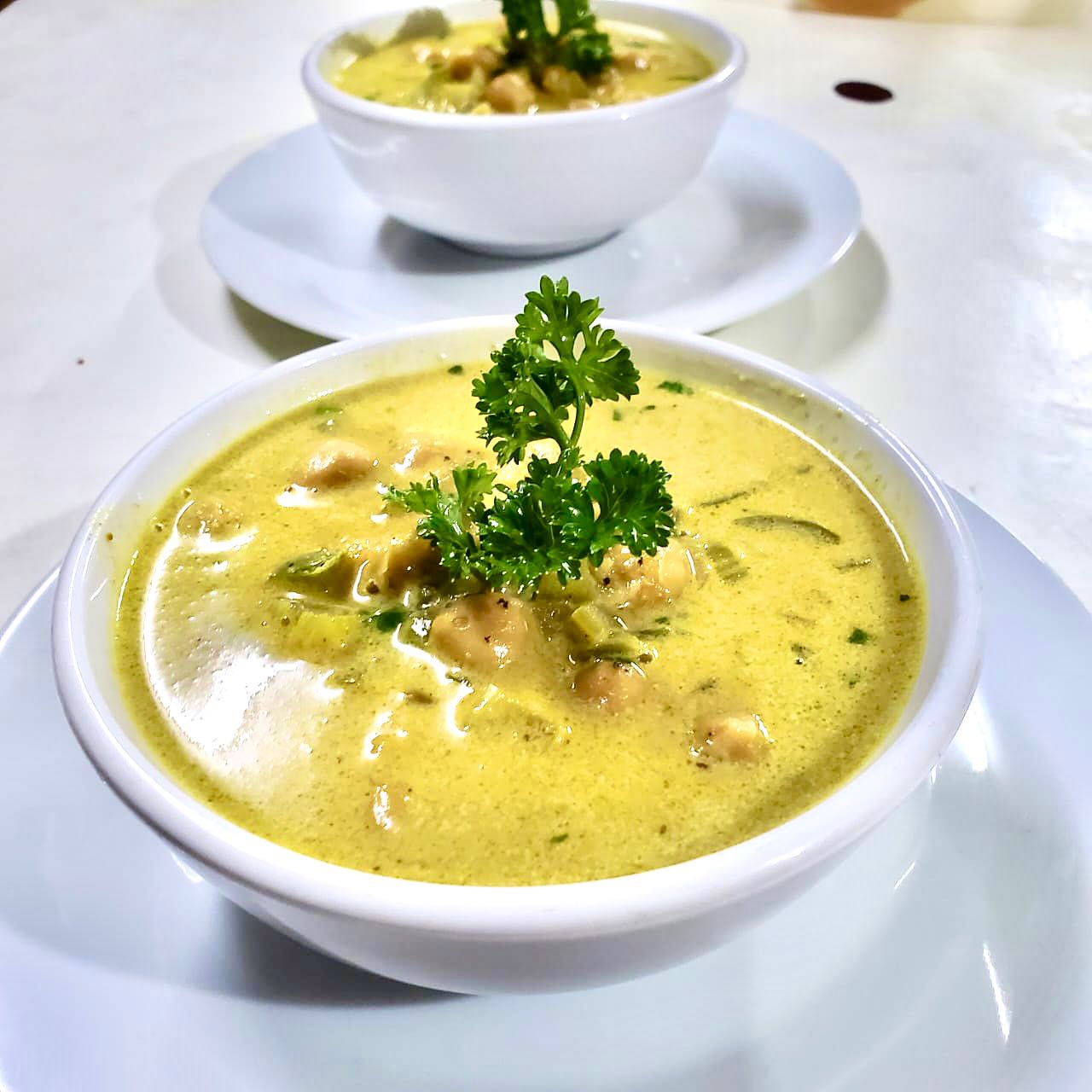 Two bowls filled with a rich, vibrant soup